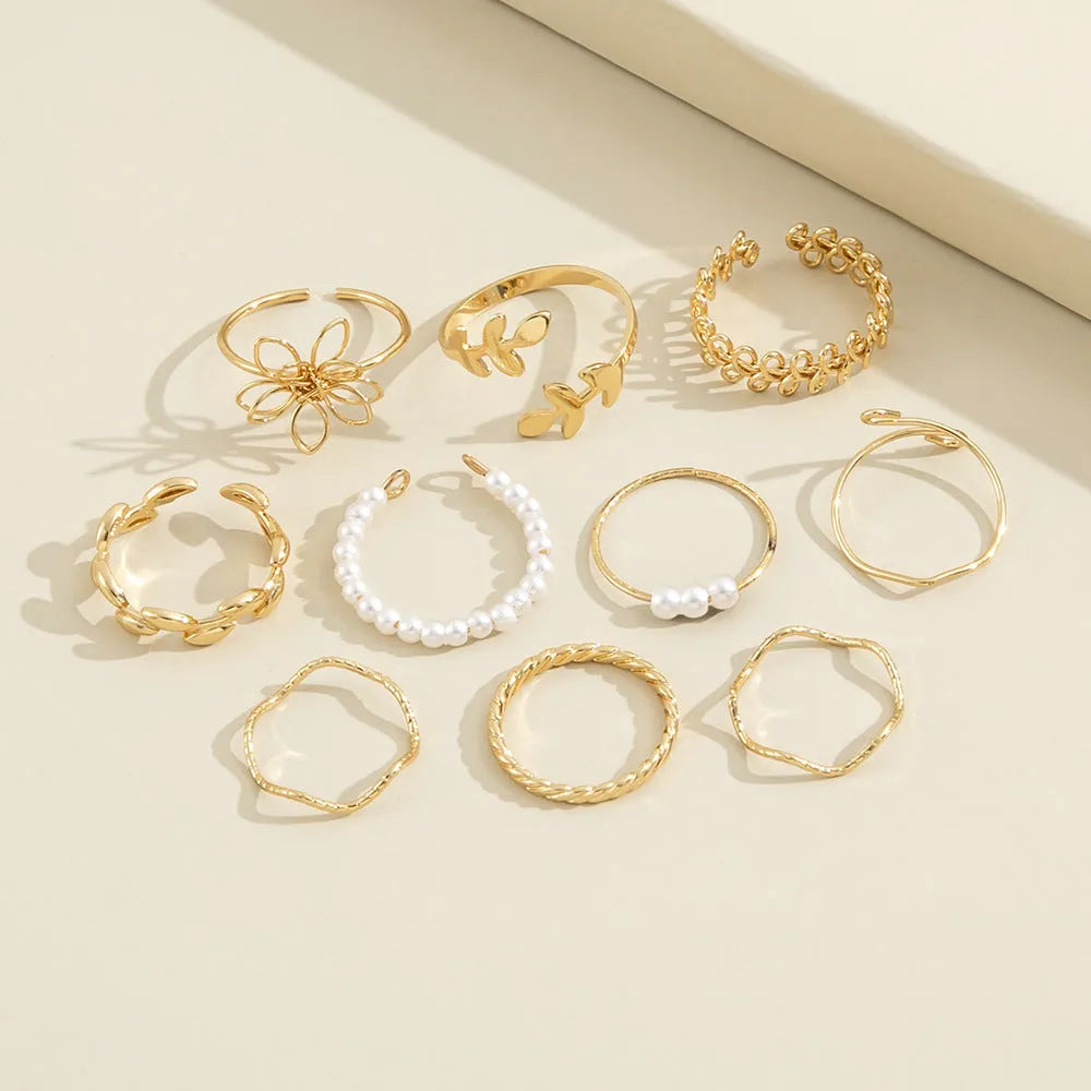Gold openwork flower ring set showing floral design and glossy electroplated finish