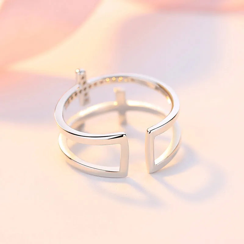 Adjustable copper ring with double cross design featuring zircon gems in sterling silver inlay, white gold colour
