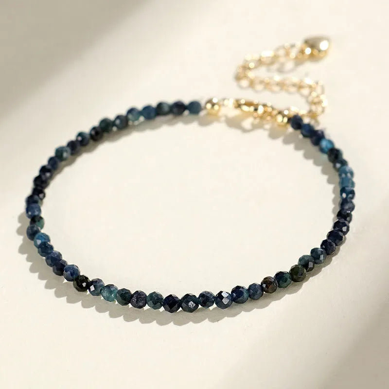 Blue tourmaline spacer bead bracelet with 3mm cut beads and blue gold accents