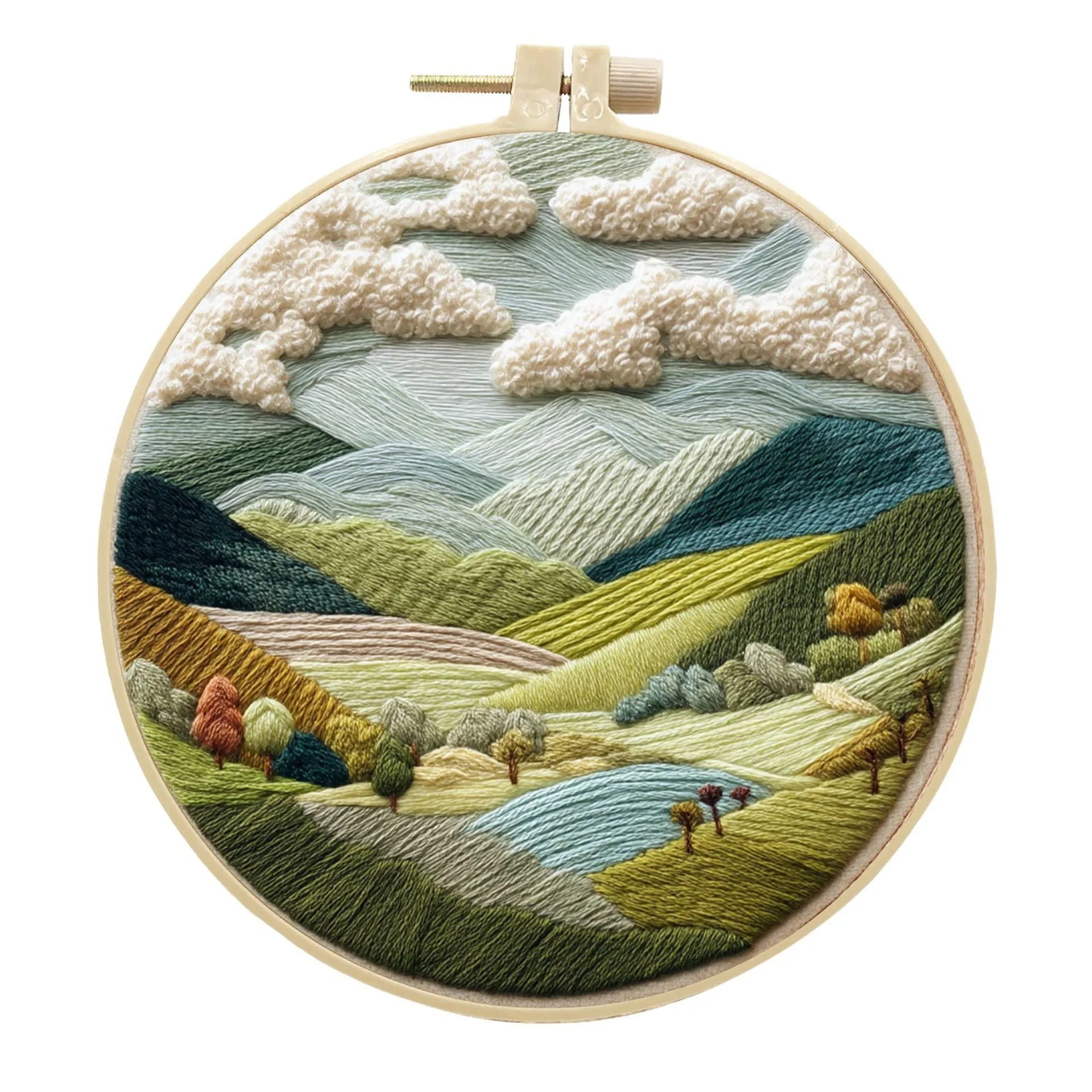 DIY landscape embroidery kit with cotton fabric, bamboo frame, threads and needles arranged for crafting