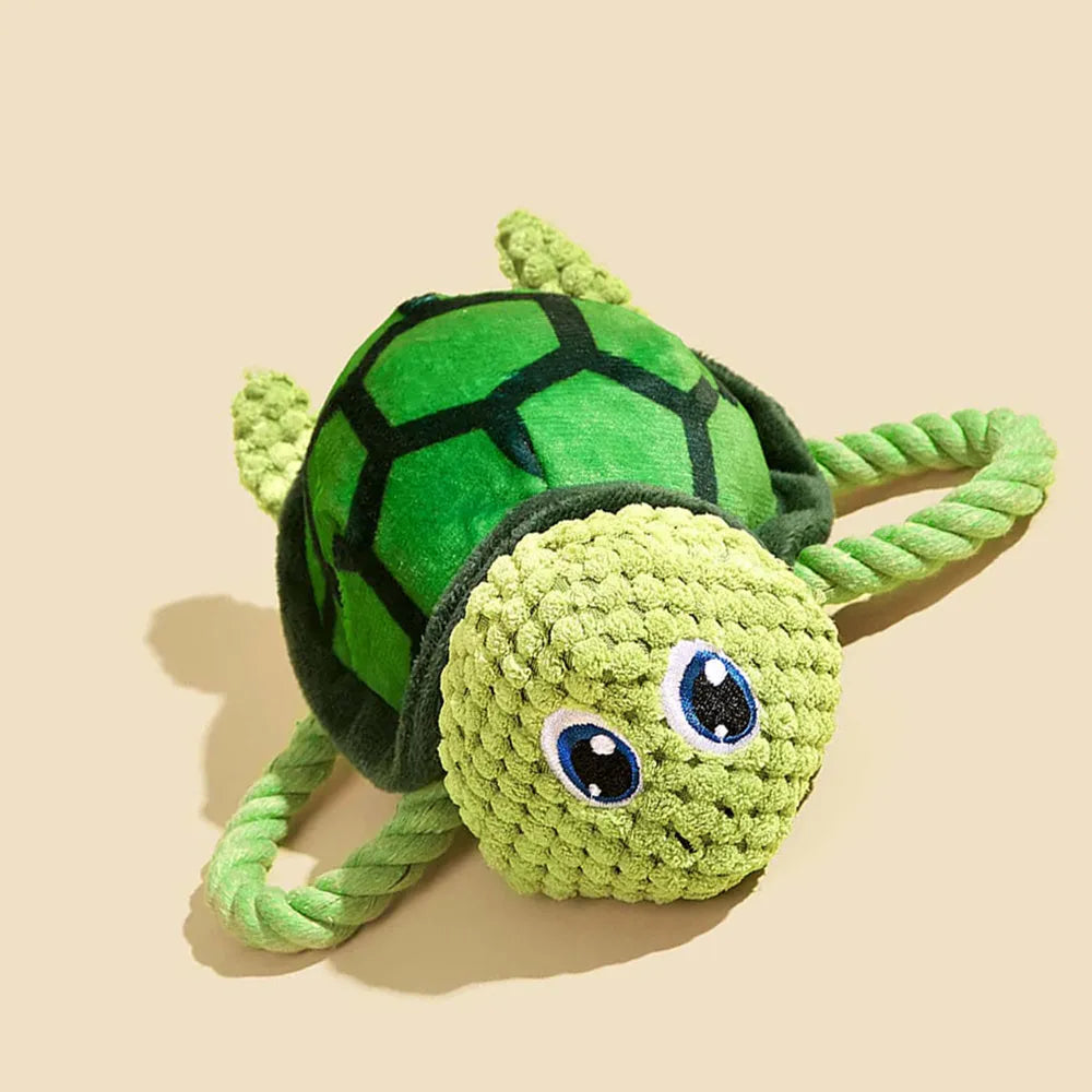 Turtle shaped dog chewing toy in gray green or orange plush fabric with knotted limbs for interactive pet play