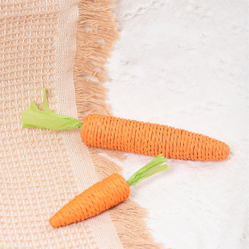Assortment of cat toys including carrot-shaped paper bites, plastic ringing stones, and textured grinding sticks in two size options