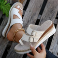 White patent leather wedge sandals with woven finger fit design and peep toe on a rubber sole.
