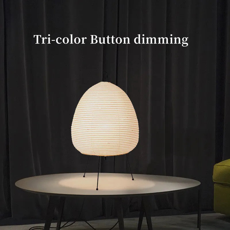 Japanese style rice paper table lamp with aluminium body and decorative shade on wooden surface