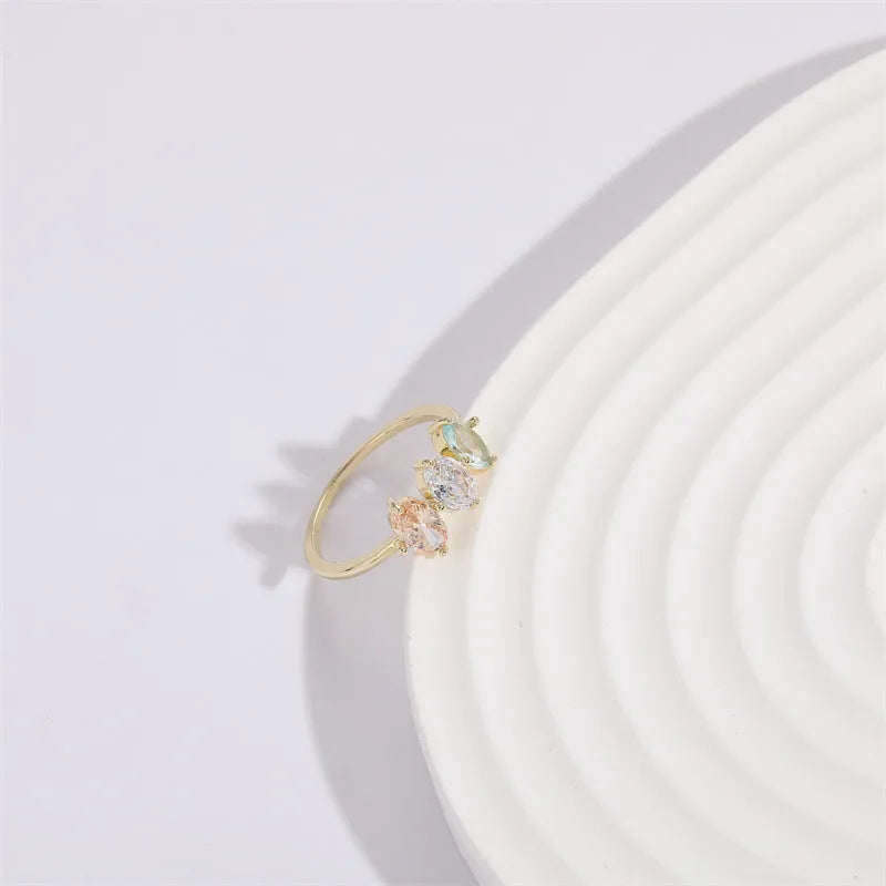 Geometric triangle women's ring with tricolor zircon horse eye design in electroplated gold.