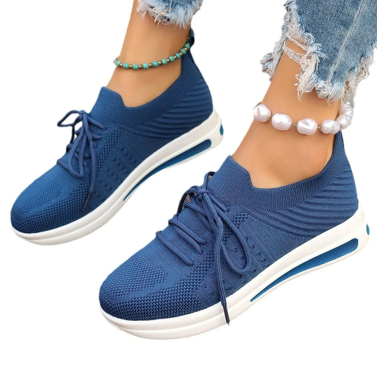 Women's black fly-knit casual sneakers with lace-up front and low-top design on a white background