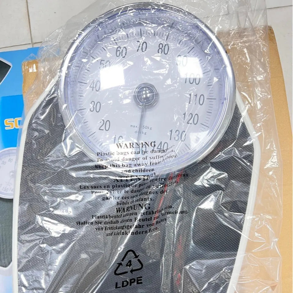 Black mechanical pointer body weight scale with large dial showing 180kg capacity