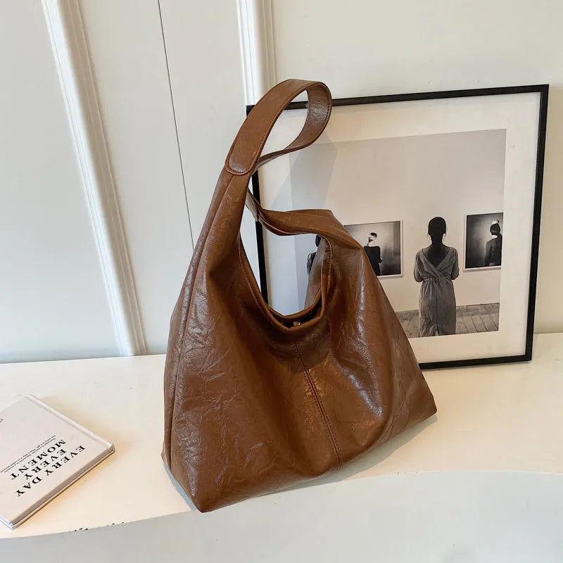 Casual soft PU leather large capacity shoulder bag in street trend style.