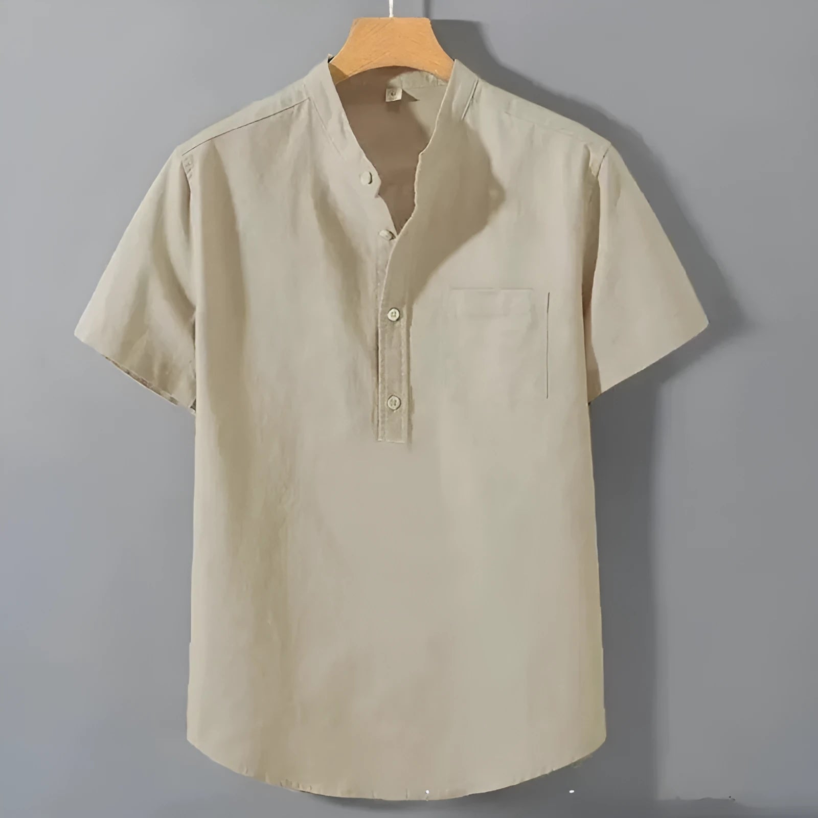 Men's beige loose-fit linen short sleeve shirt with a stand collar on a hanger.