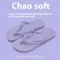 Orange foldable beach slippers with a hollow-out plastic upper and non-slip PVC sole on a sandy background.