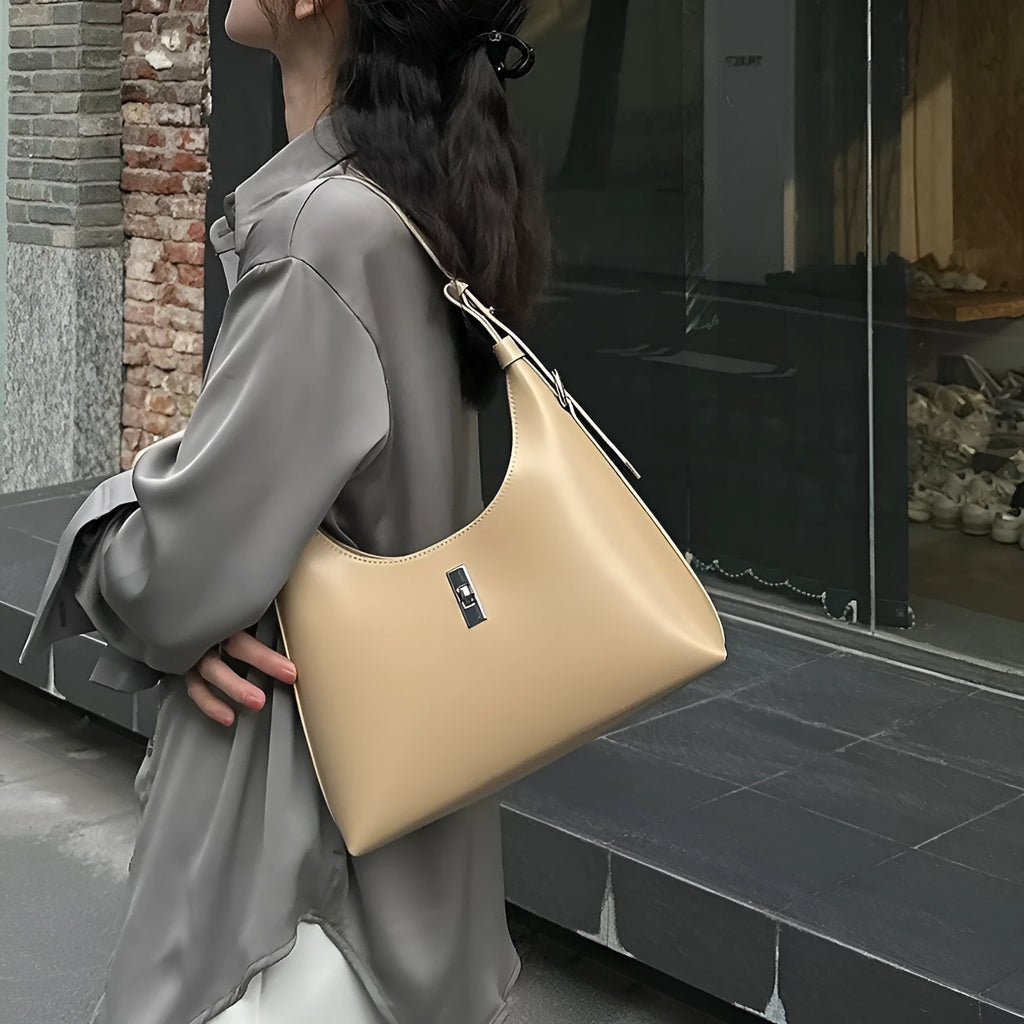 Genuine leather dumpling-shaped crossbody shoulder bag in apricot colour with a front sandwich pocket.