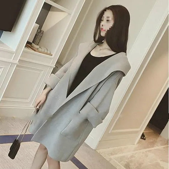 Plus size woman modelling a loose-fit grey cotton coat with lace detail on the sleeves.
