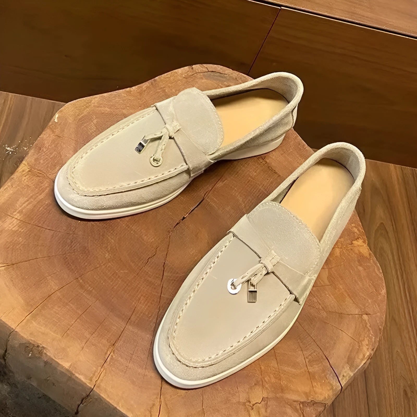 Unisex high-top slip-on loafers with a round toe cap and rubber sole on a neutral background.