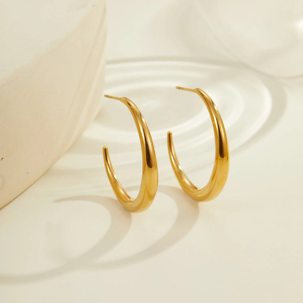 Geometric round stainless steel hoop earrings with gold plating, shown in large and small sizes.