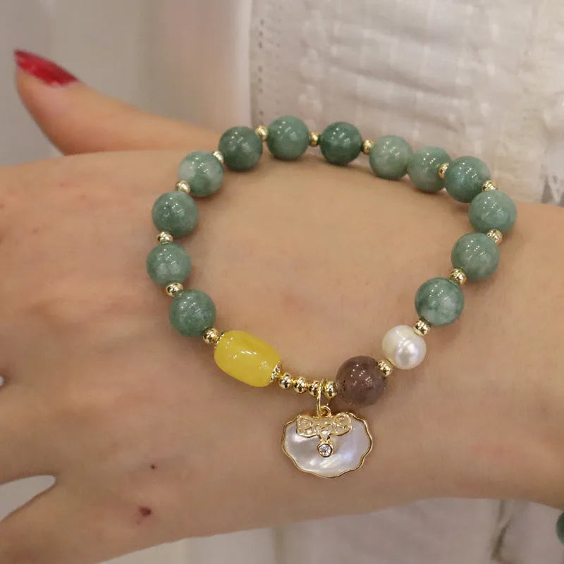Green jade bracelet with carved shell charm and adjustable silver-tone clasp