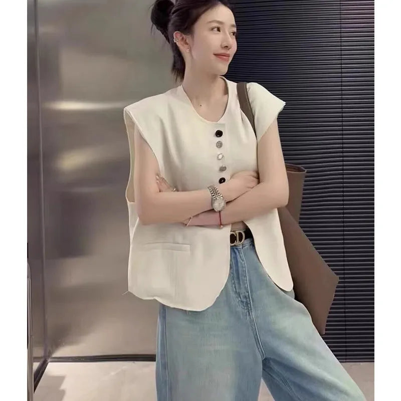 Women's loose fit polyester vest in milky white with pocket detail and 40cm length