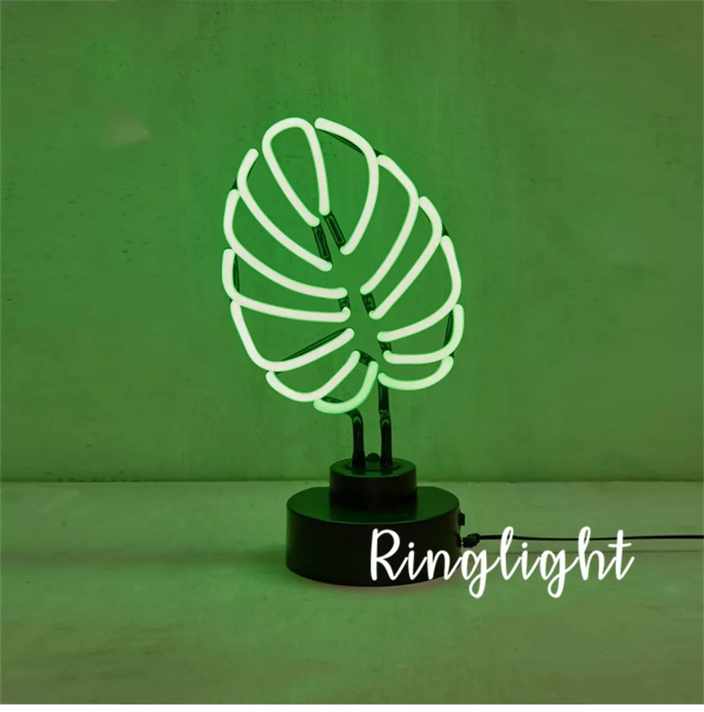 Creative minimalist bamboo-shaped desk lamp with green light on a white background.
