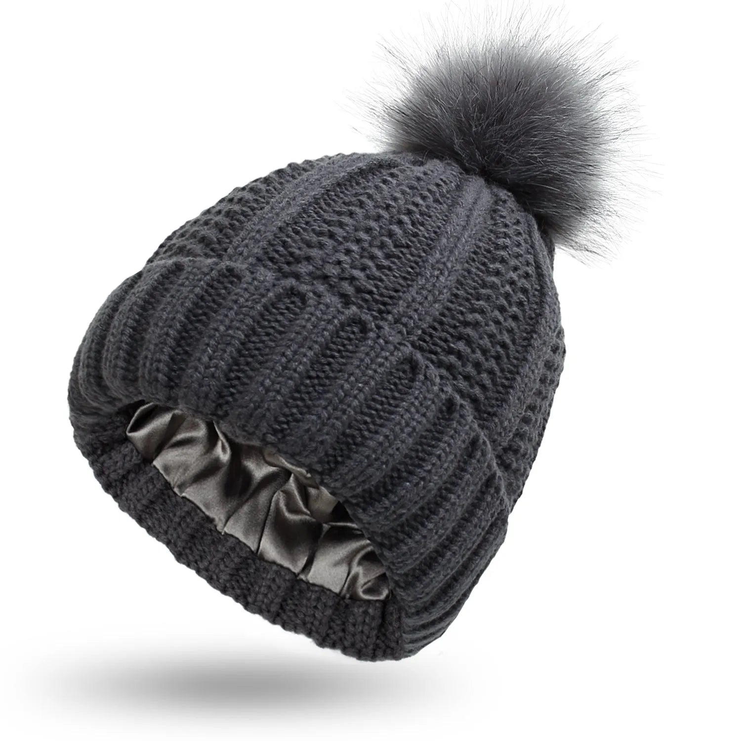 Woman wearing a light grey wool beanie with a faux fur pom pom and satin lining.