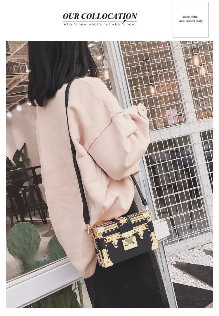 Black PU hard-sided women's shoulder bag with flap closure and decorative rivets
