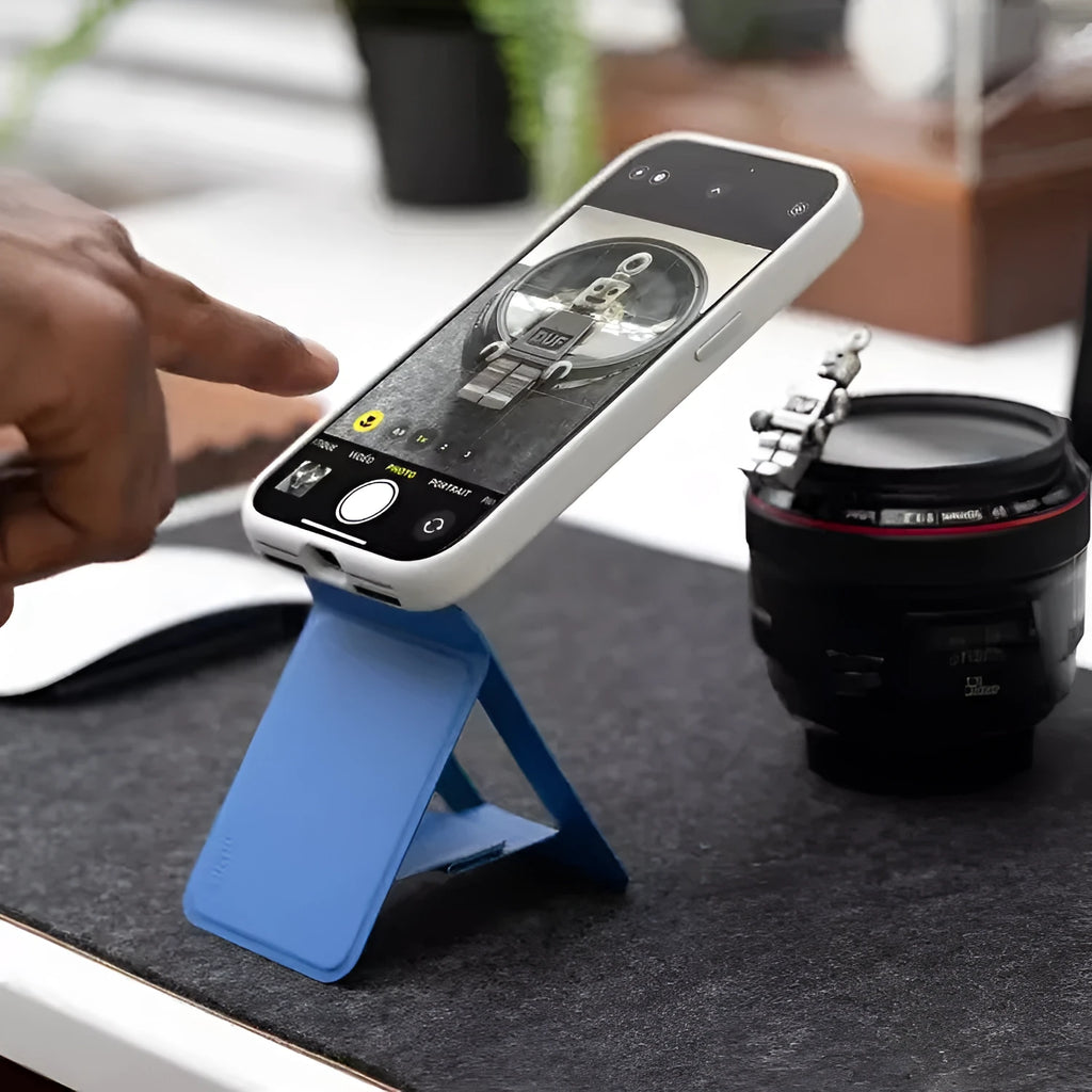Black magnetic mobile phone case with integrated kickstand deployed, showing slim profile and leather finish.