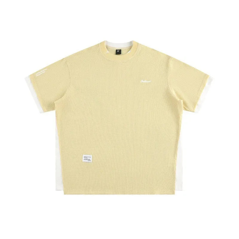Loose fit short-sleeved waffle fabric t-shirt with retro alphabet embroidery, shown in yellow.