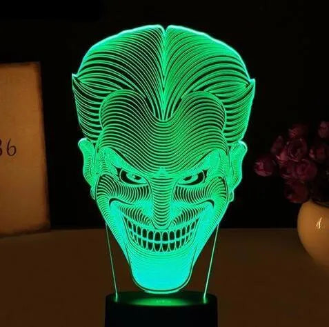 USB-powered 3D acrylic LED table lamp showing seven colour options on a desk