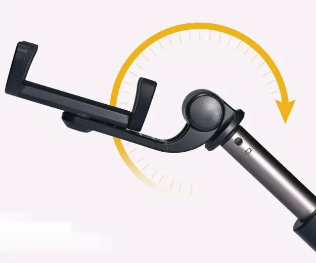 Aluminium Bluetooth selfie stick with tripod base and remote control next to a mobile phone.