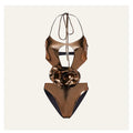 Handmade gold halter neck one-piece swimsuit with hollow out design on a mannequin.