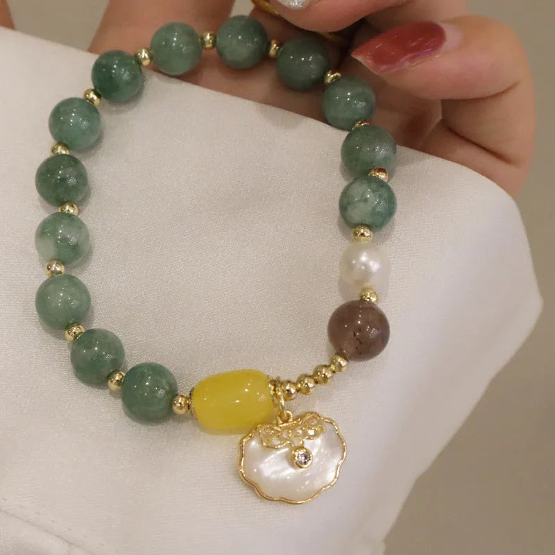 Green jade bracelet with carved shell charm and adjustable silver-tone clasp