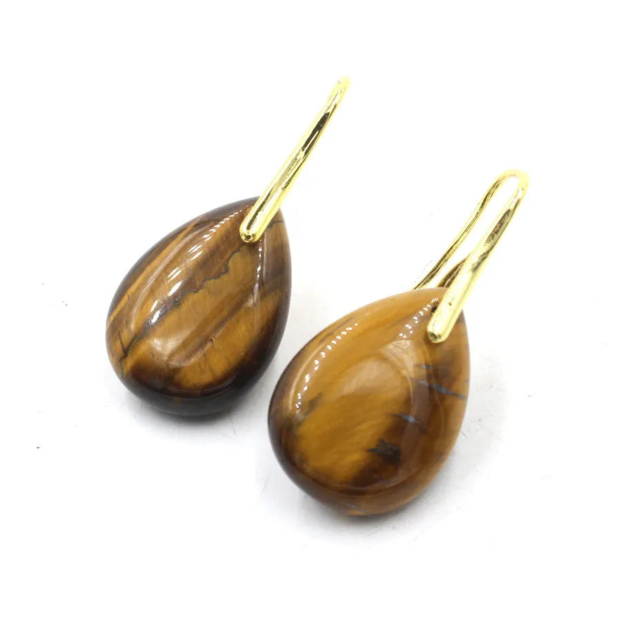 A pair of geometric water drop earrings made from crystal in one of nine colours, with an electroplated metal setting.