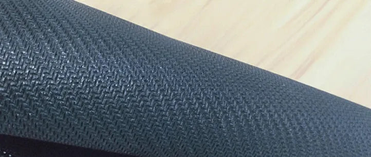 Large natural rubber desk mouse pad with a printed geometric pattern, showing non-slip base.