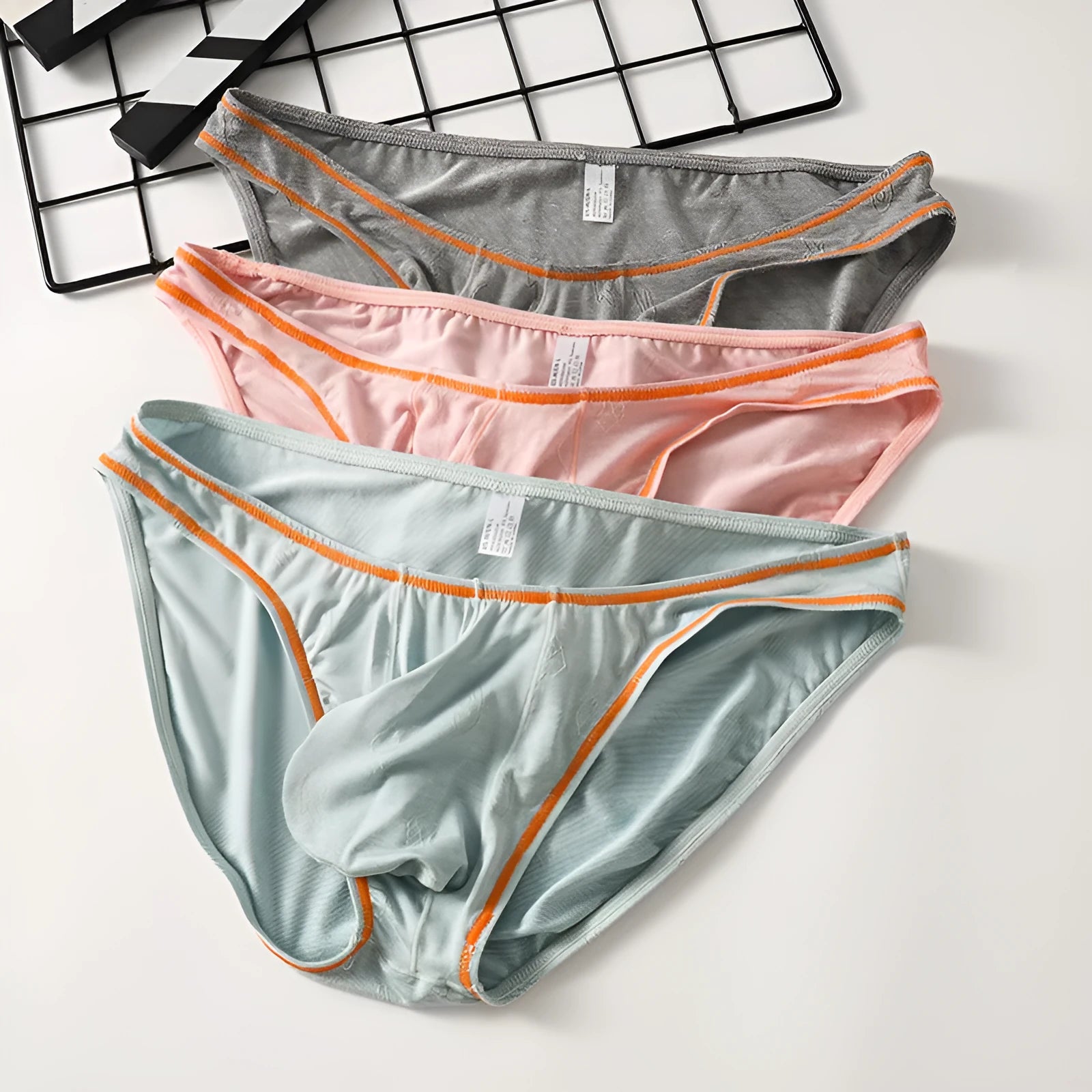 Men's ice silk modal butt-lift underwear shown in dark gray, pink, yellow green, blue, and sky blue colours.