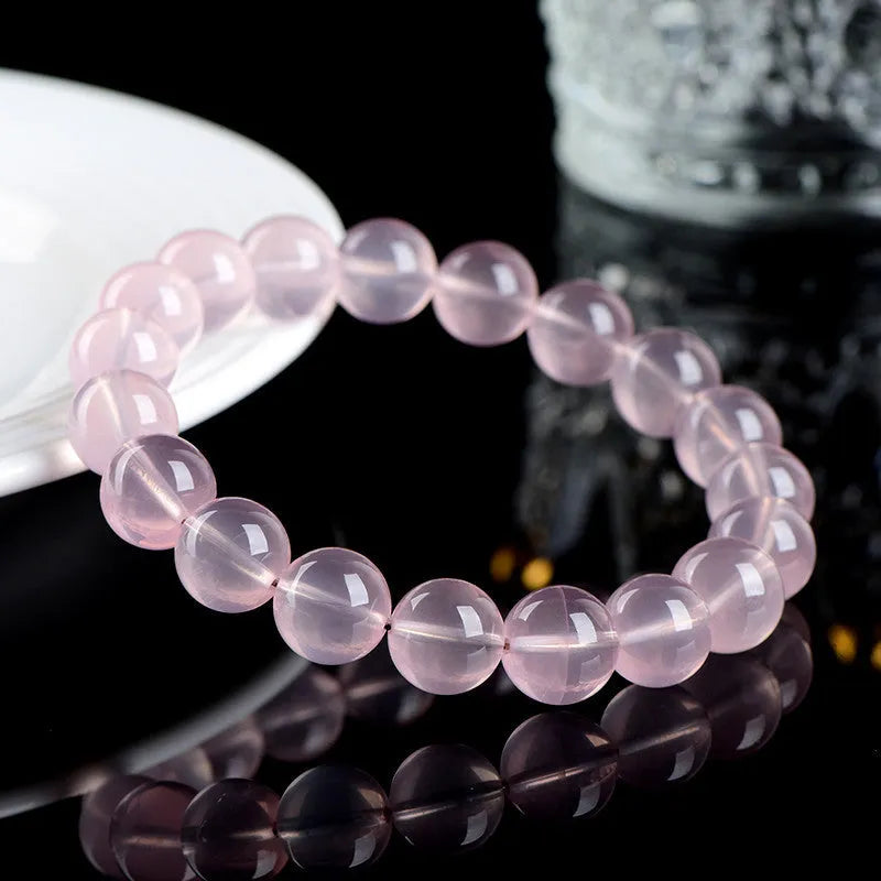 Natural pink starlight crystal round bead bracelet with polished finish in various sizes from 6mm to 22mm