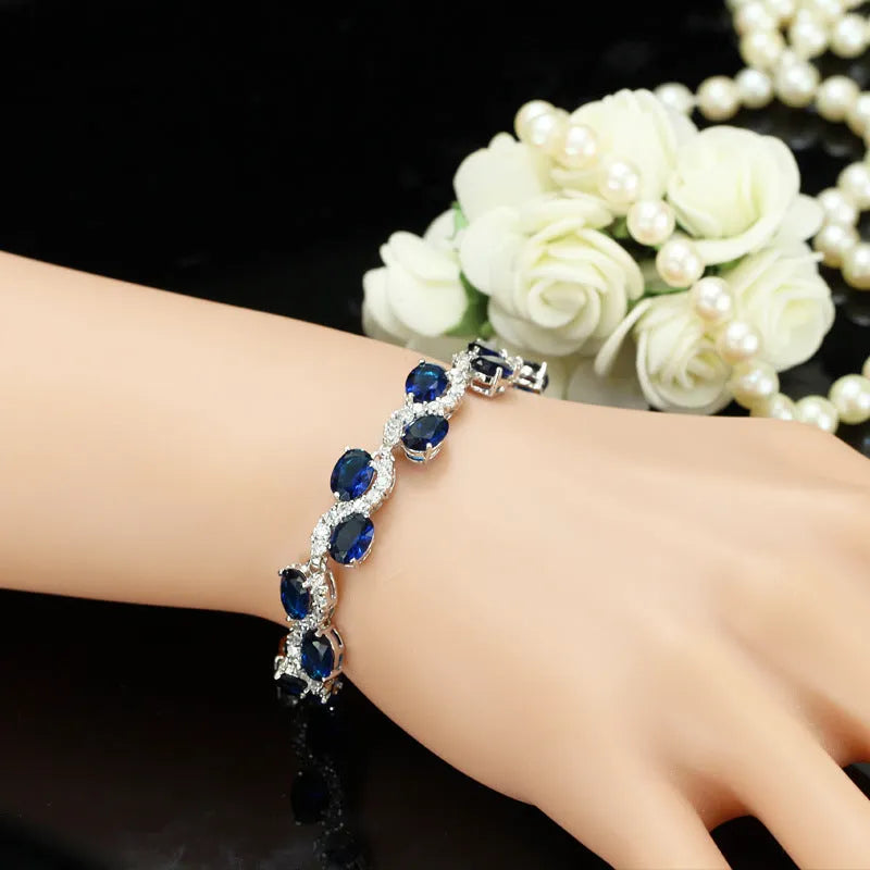 Geometric gold electroplated women's bracelet with inlaid zircon stones, shown in one of five colour options.