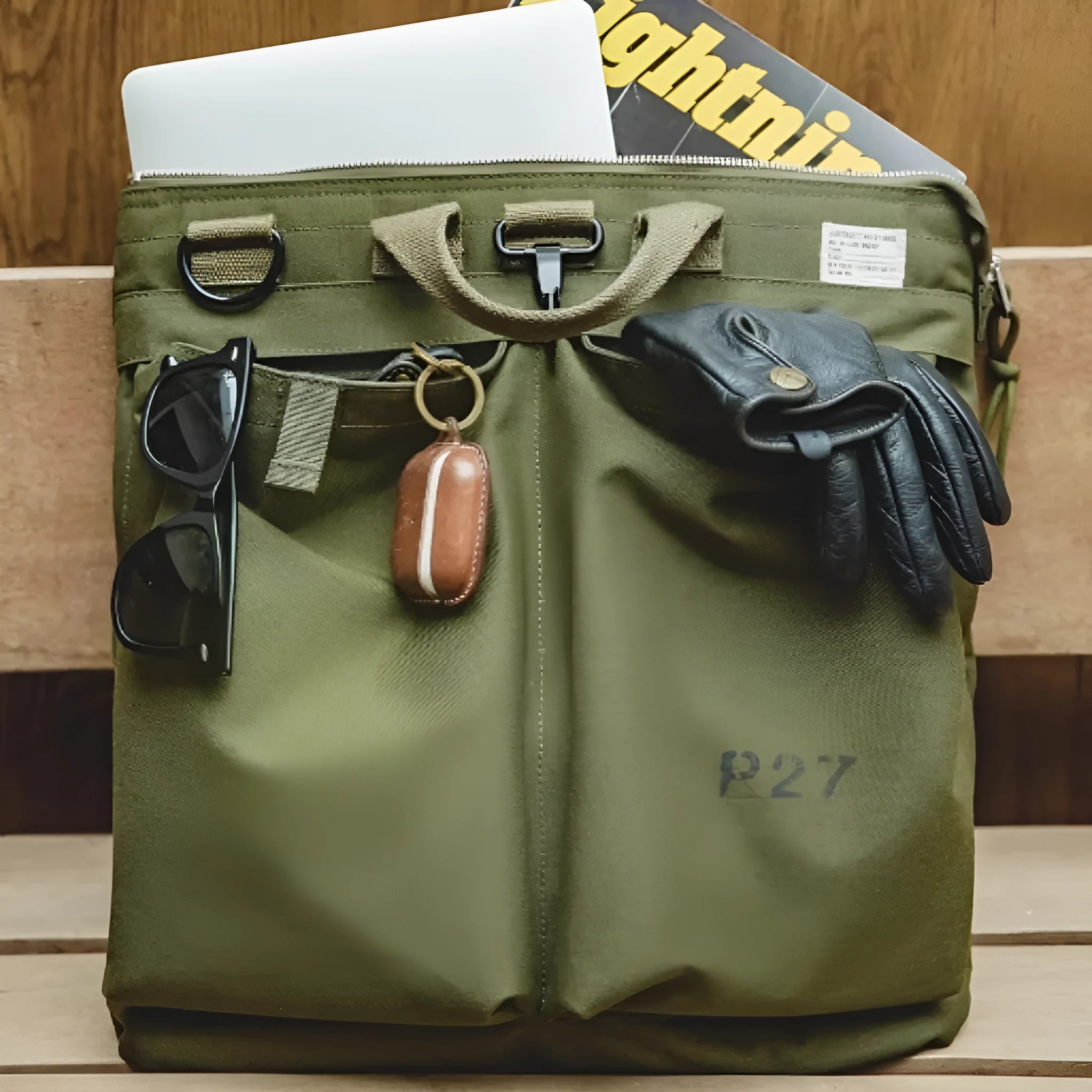Canvas crossbody messenger bag in military green colour with shoulder strap and hard handle