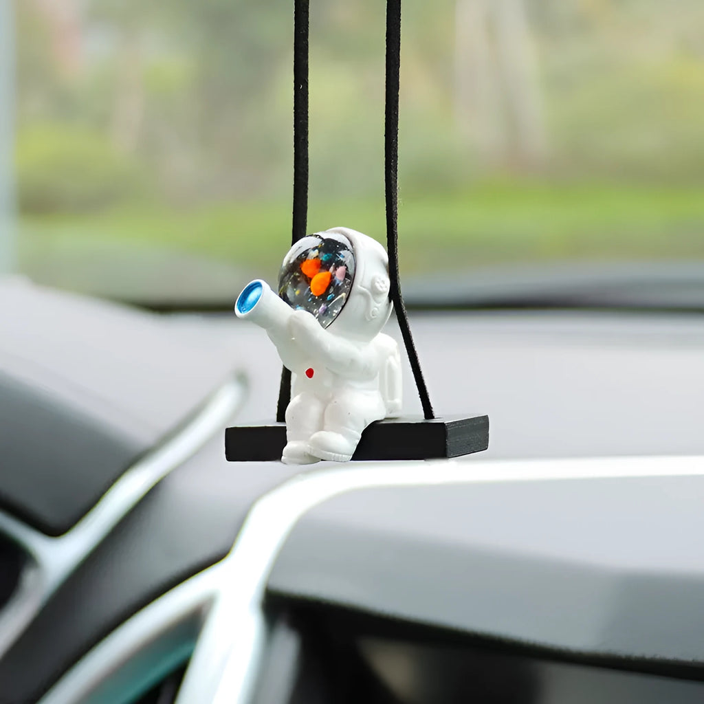 Resin cartoon astronaut car pendant showing designs like astronaut with telescope and astronaut holding a radish.