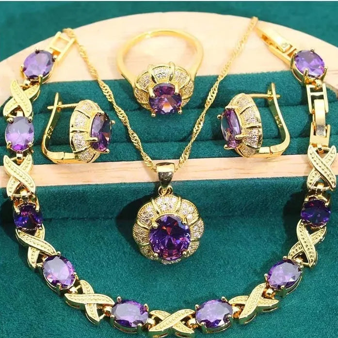 18k gold plated zircon jewellery set showing necklace, earrings, ring, and bracelet with synthetic cubic zirconia stones