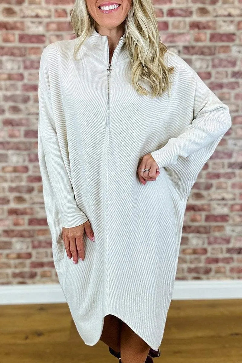 Women's solid colour loose knitted dress with raglan sleeves, shown in dark green.