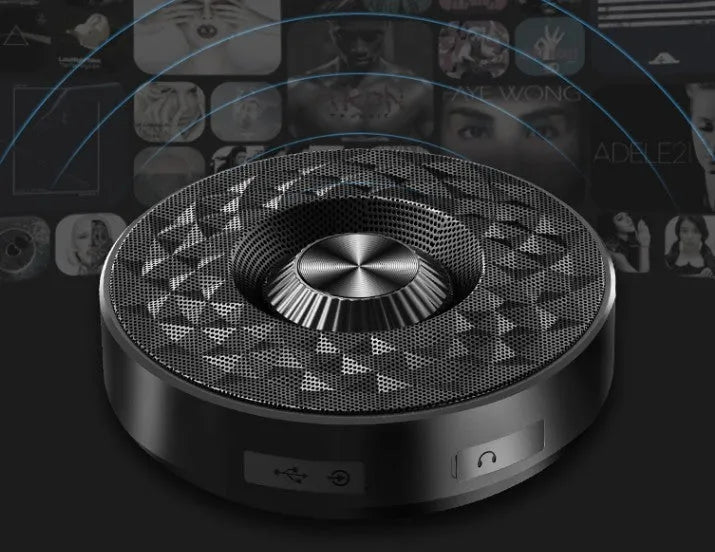 Mini circular Bluetooth speaker in black, orange and silvery white colours showing compact design