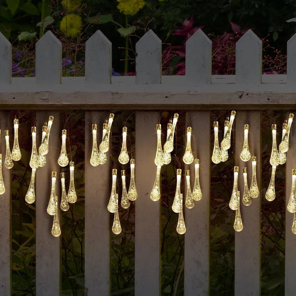 Solar-powered LED Water Drops string lights with ABS plastic pendants on a 6.5 metre wire for outdoor gardens.