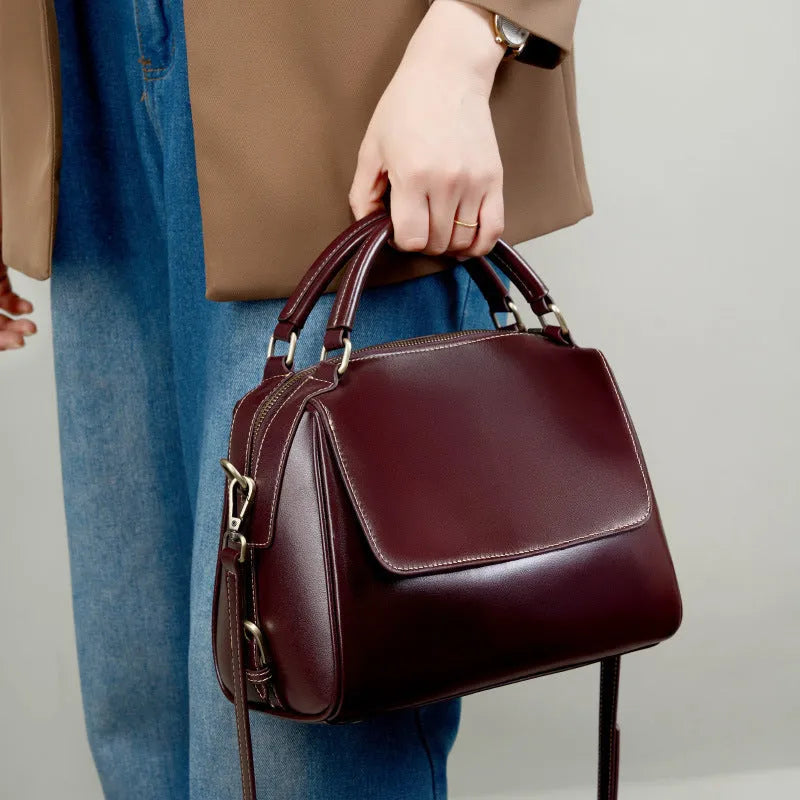 Women's soft genuine leather crossbody tote bag in a square shape with a double strap, shown in apricot colour.