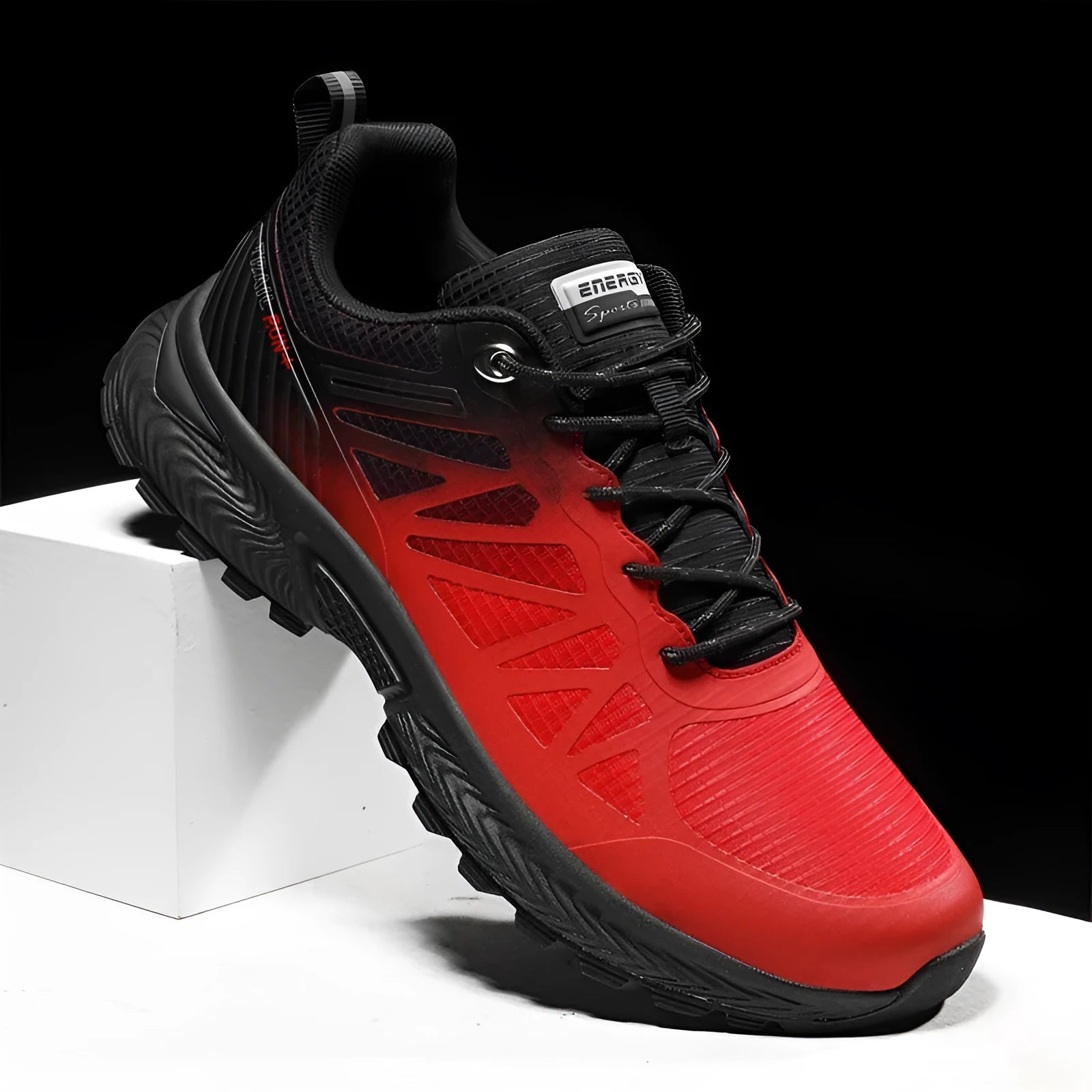Men's black and orange mesh outdoor running shoe with round toe and flat heel on a rubber sole.