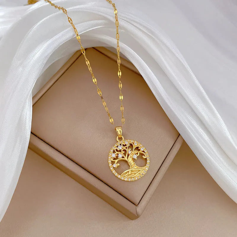 Gold-plated necklace with rhinestone lucky tree pendant and mother of pearl cross on adjustable chain