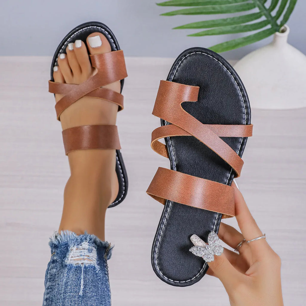 Casual one-line beach slippers in black with hollow out design and artificial PU upper.