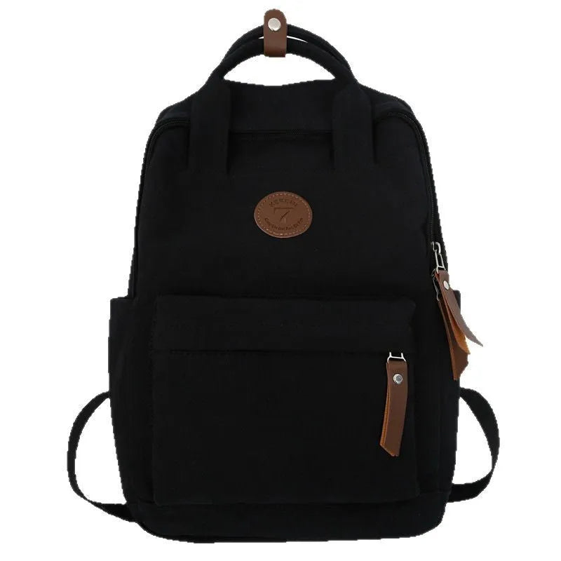 Solid black retro Oxford cloth backpack with curved shoulder straps on a neutral background.