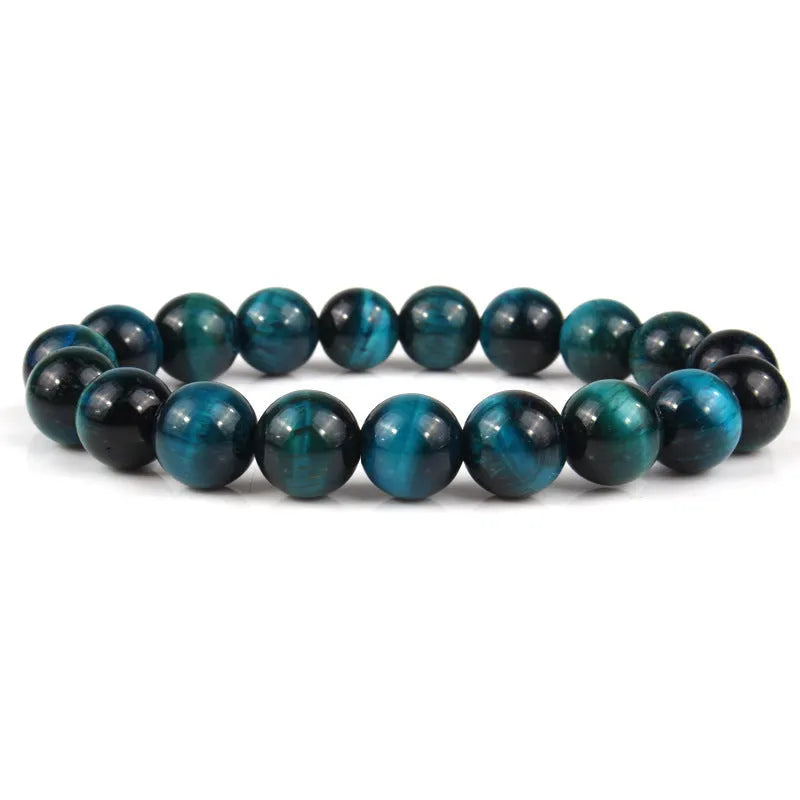 Tiger eye crystal stone bracelet showing round beads available in multiple colours and sizes on a wrist.