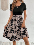 Women's khaki floral print lace-up A-line dress with shoulder straps on a hanger.