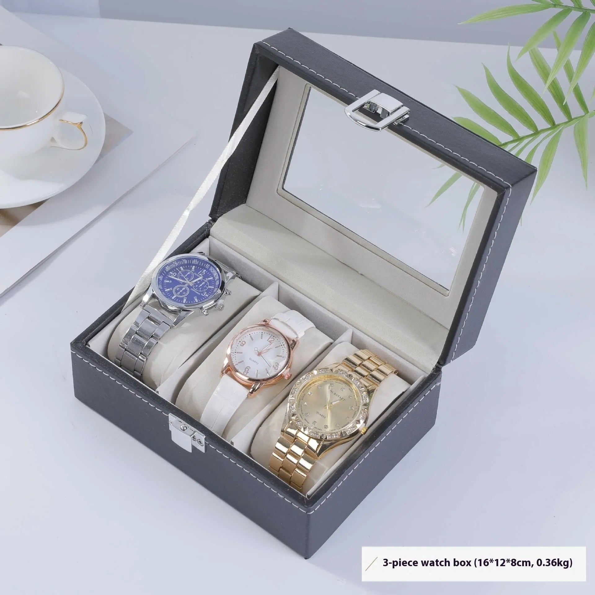 Grey leather watch storage box with clear lid showing watch compartments