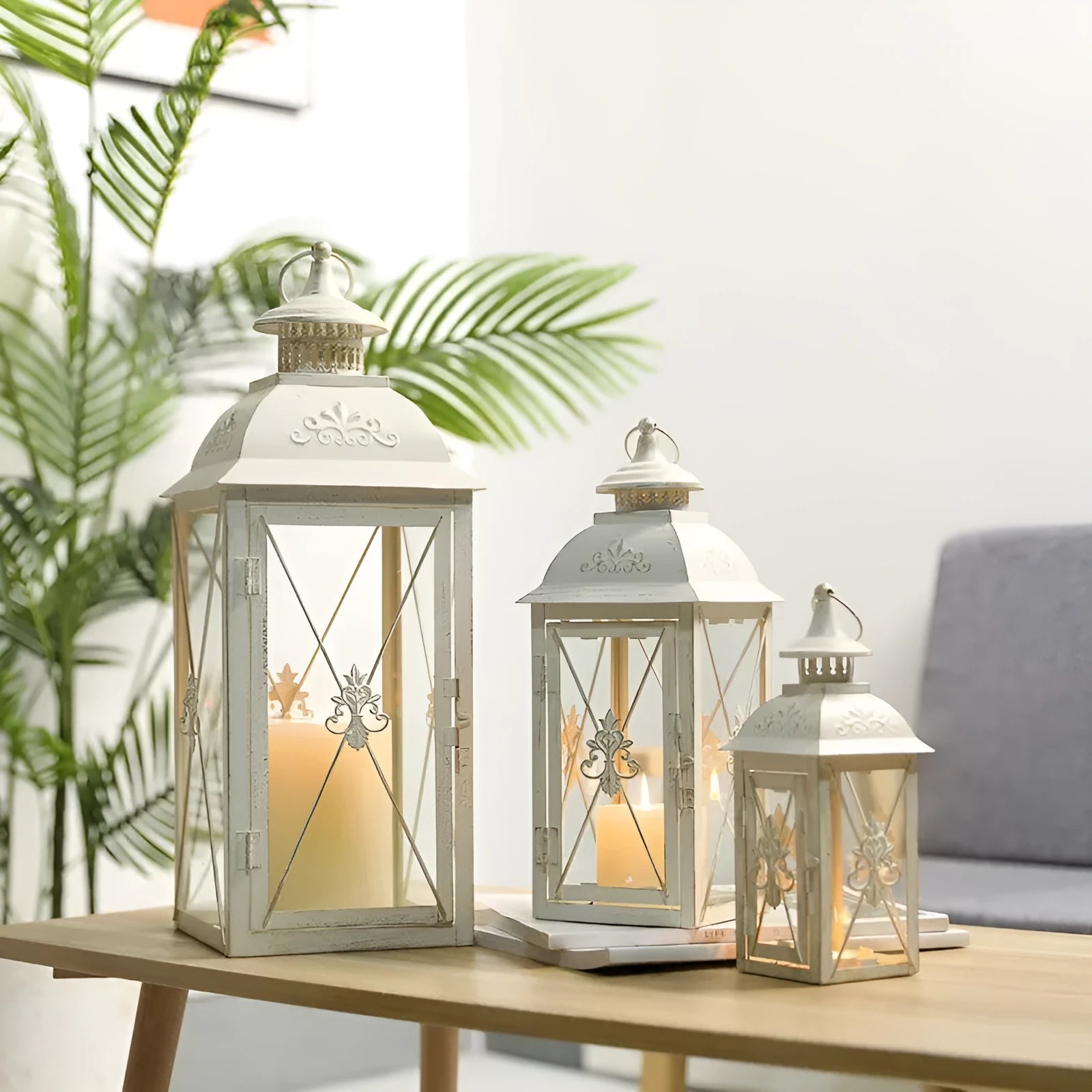 Black wrought iron floor-standing storm lantern with tempered glass panels for outdoor candle lighting