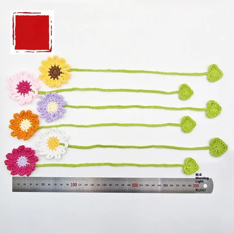 Hand-crocheted daisy flexible wire bookmark in yellow, pink, light purple, and orange colours.